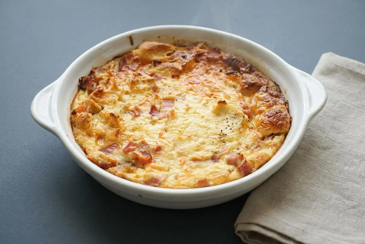 Pudding salé au jambon gratiné et doré dans un petit plat à gratin.